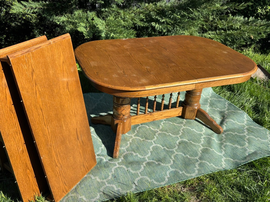 Wooden table with a green mat on grass