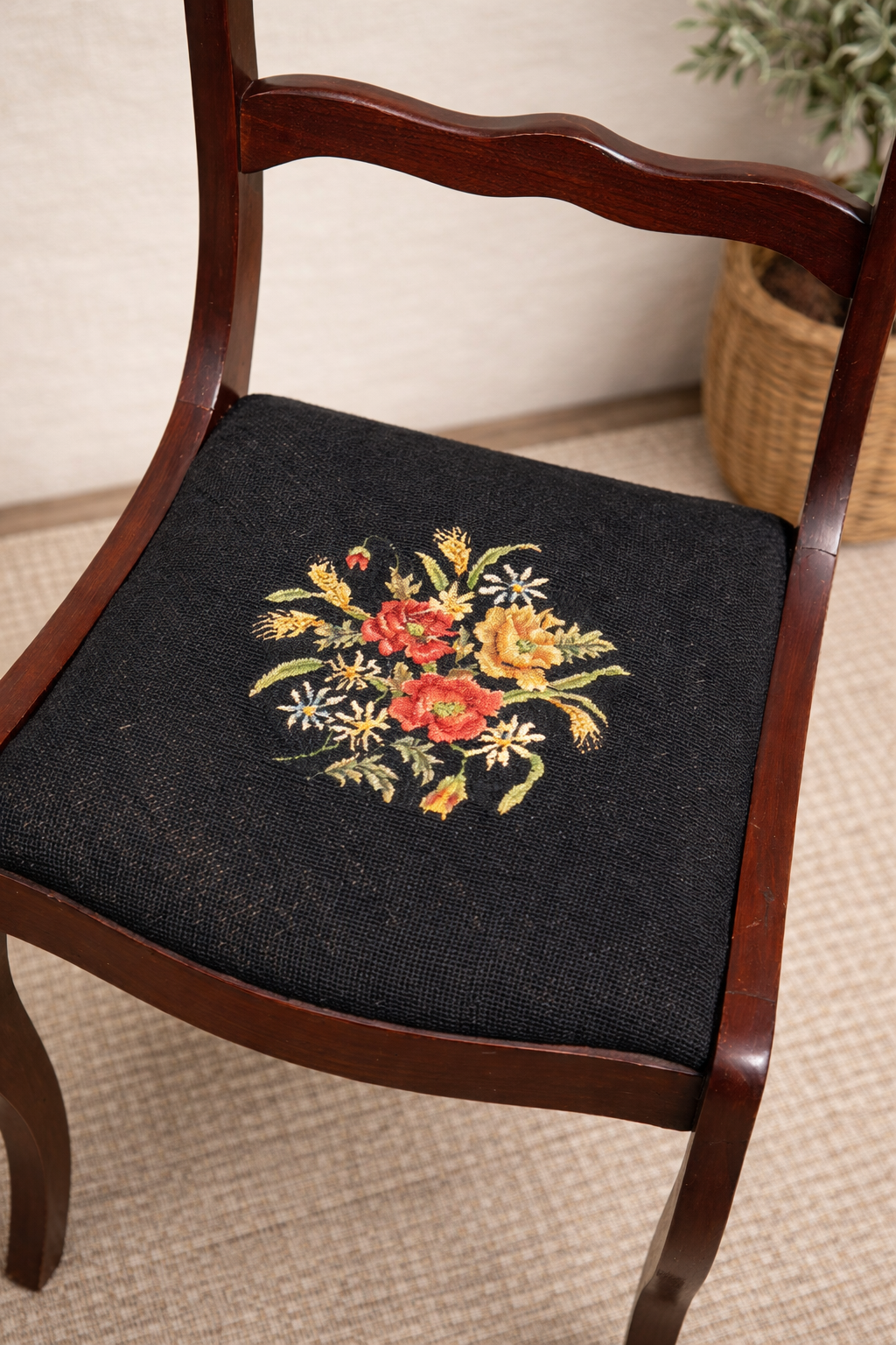 Chair with a floral embroidered cushion on a beige carpet