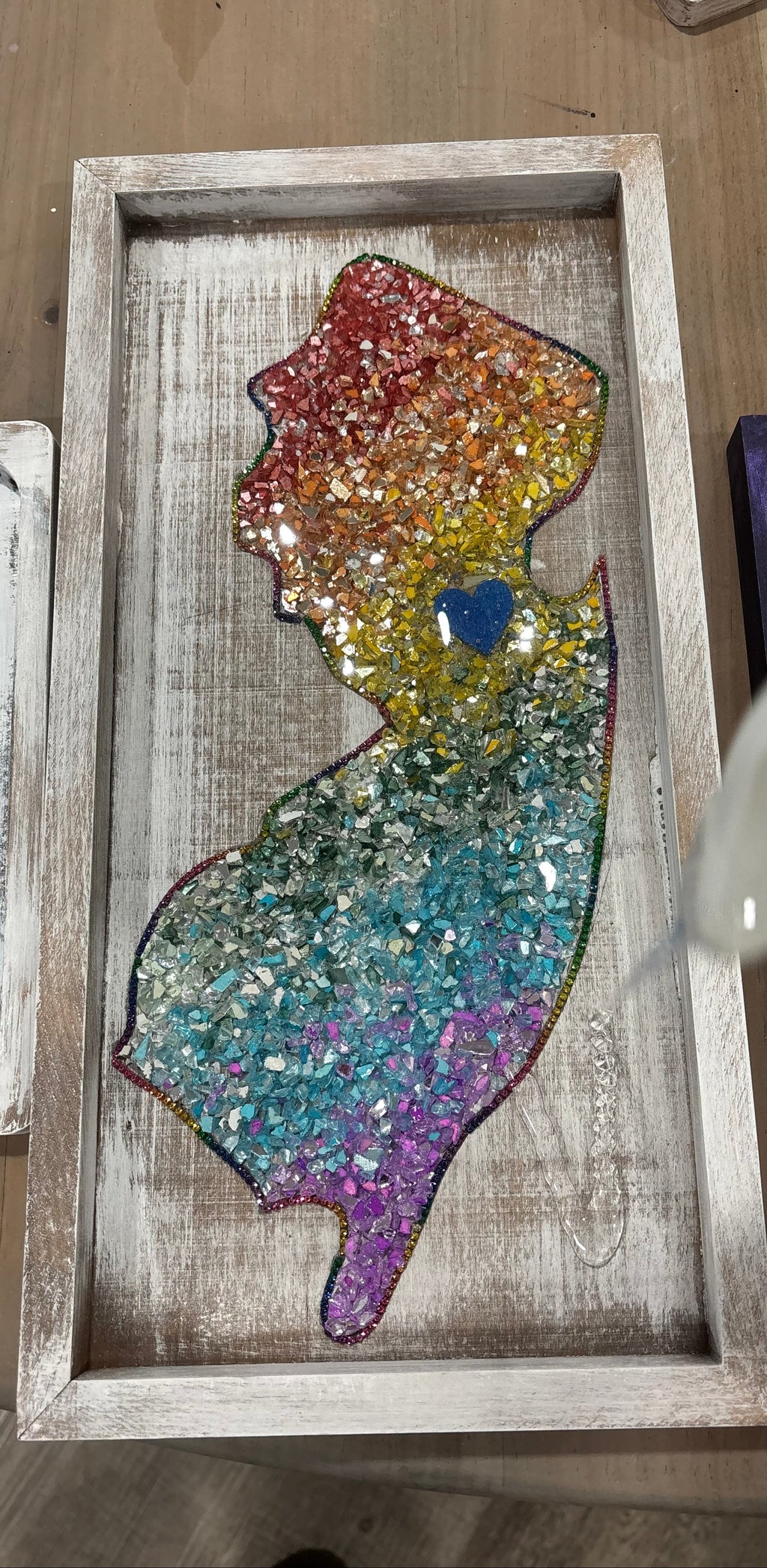 Colorful crushed glass New Jersey on a wooden tray 