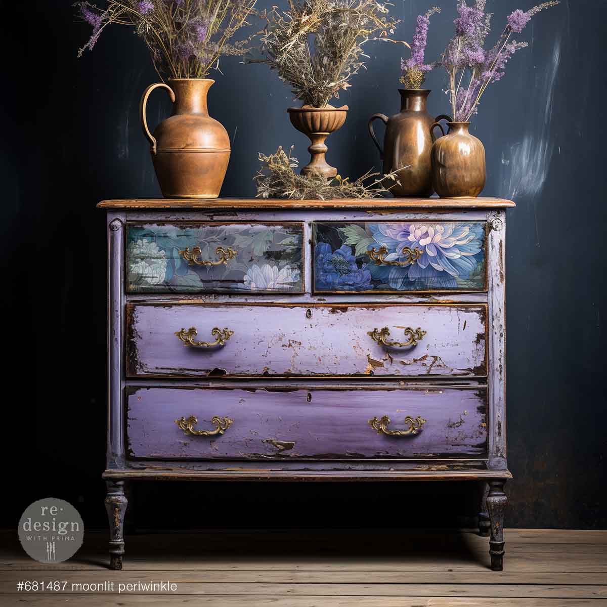 Vintage dresser with floral paint design and decorative vases on top against a dark background