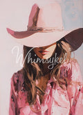 Person wearing a pink cowboy hat and shirt 