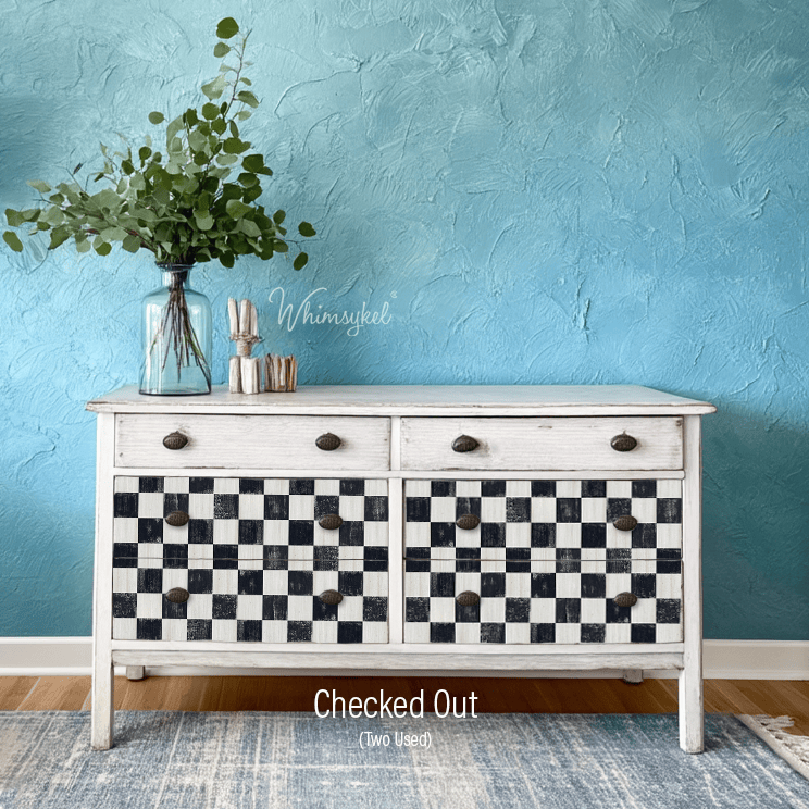 White dresser with black and white checkered pattern against a blue wall